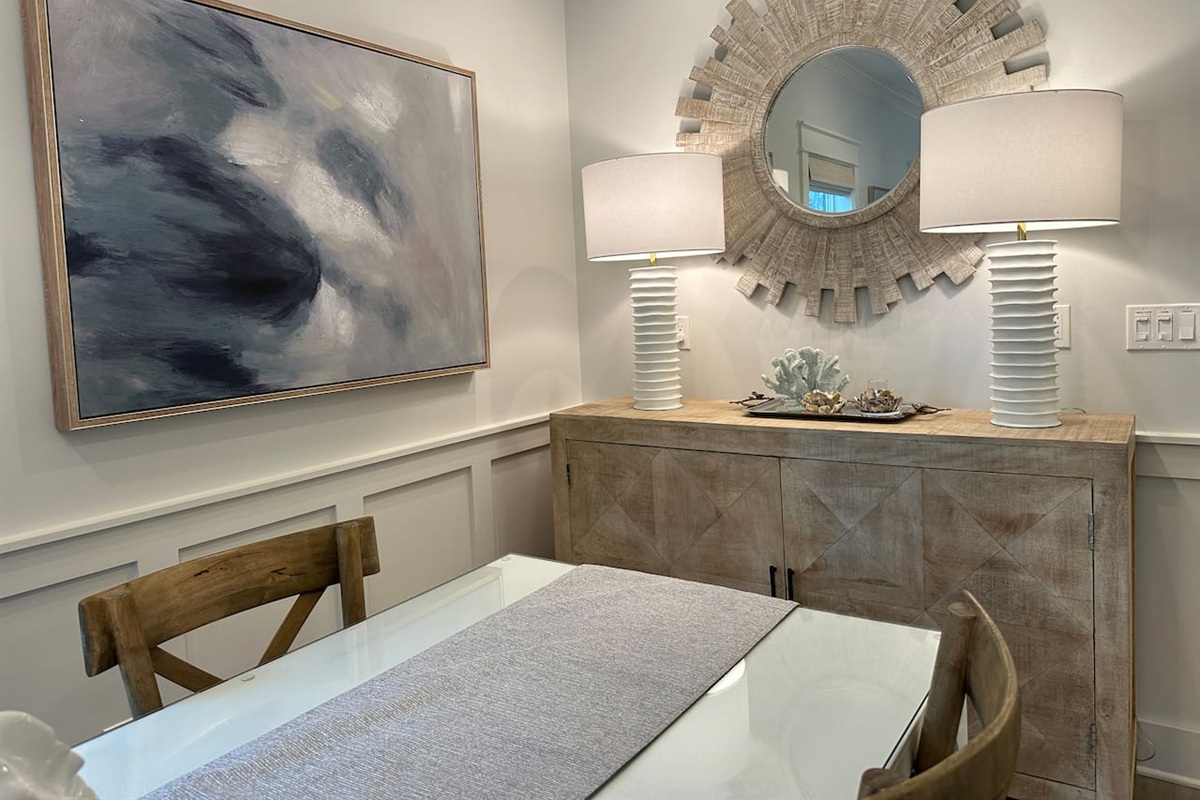 Dining area with buffet that includes games, cards and place settings for table