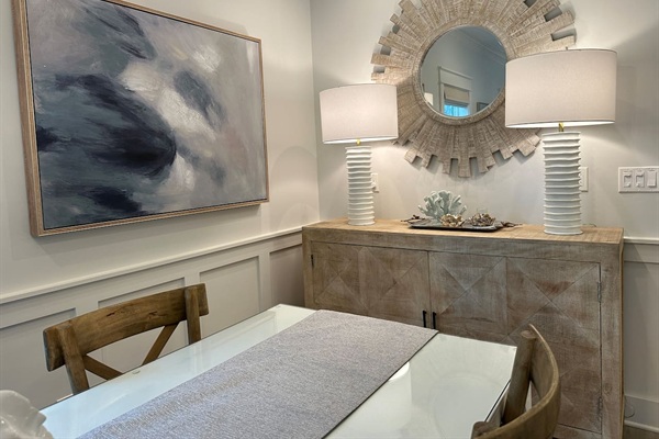 Dining area with buffet that includes games, cards and place settings for table