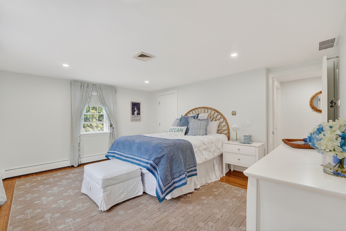 A charming second bedroom designed for rest and relaxation on a queen bed!