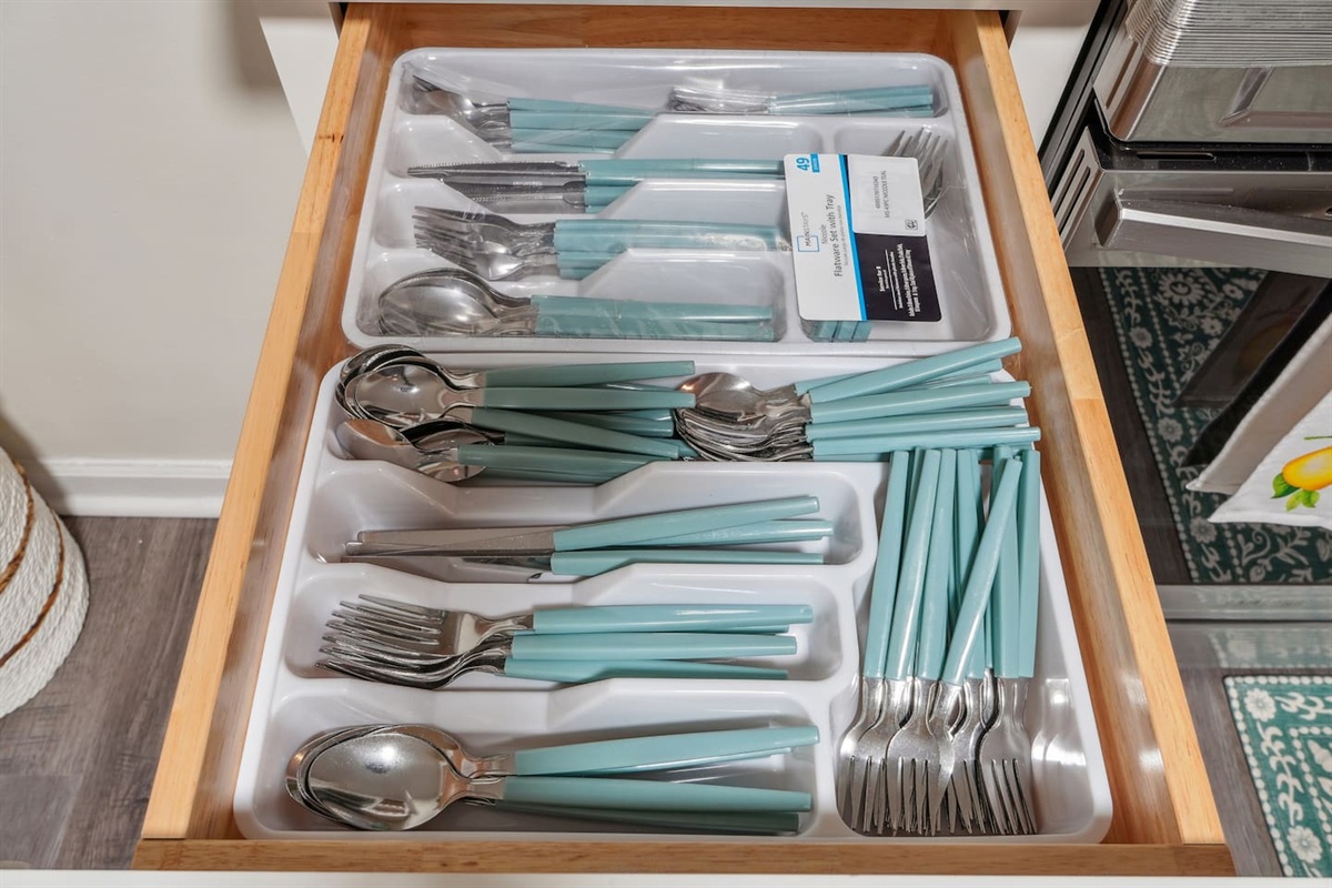 A fully equipped kitchen with a refrigerator, microwave, stove, oven,fridge, dishwasher, coffee maker, kettle, toaster, and blender. Includes plates, bowls, utensils, pots, and pans, plus four bar chairs for casual dining or socializing.
