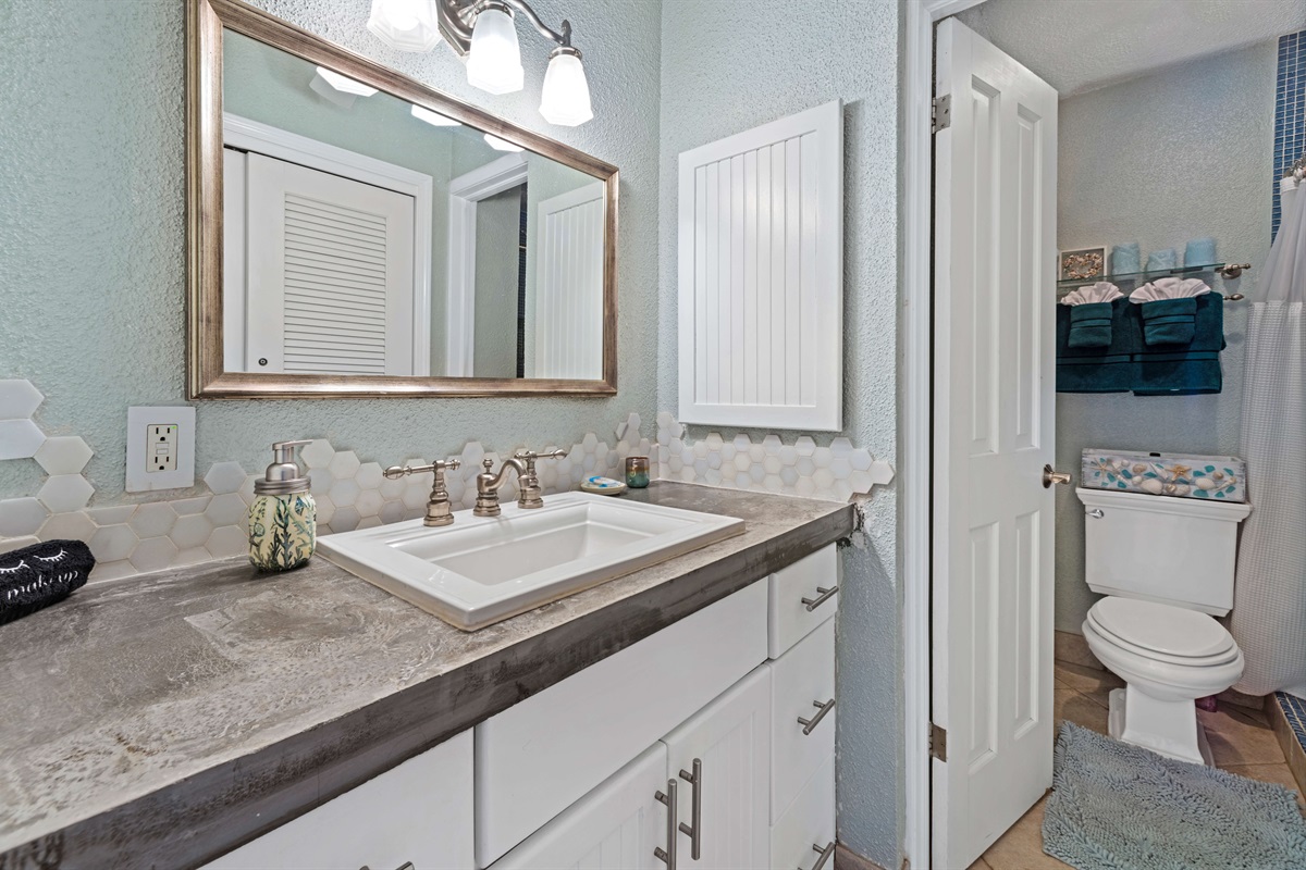 Fresh and updated guest bathroom with thoughtful details and essentials provided.