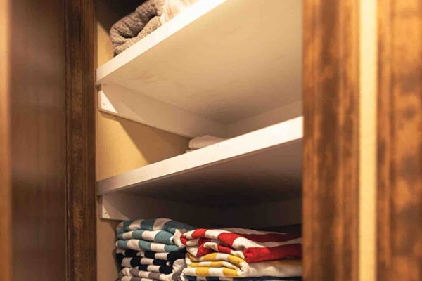 Linen closet with pool towels and extra blankets