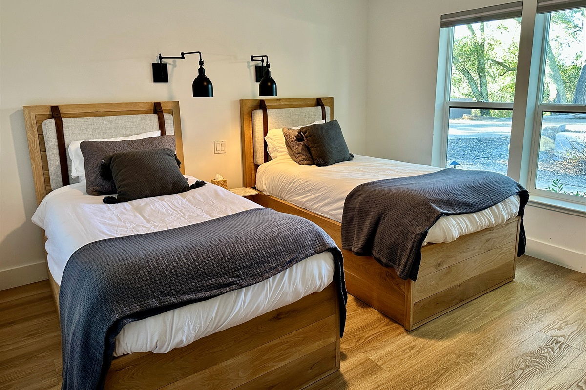 A sun-drenched retreat designed for relaxed comfort, with dual beds offering a stylish shared space for an airy, private feel.