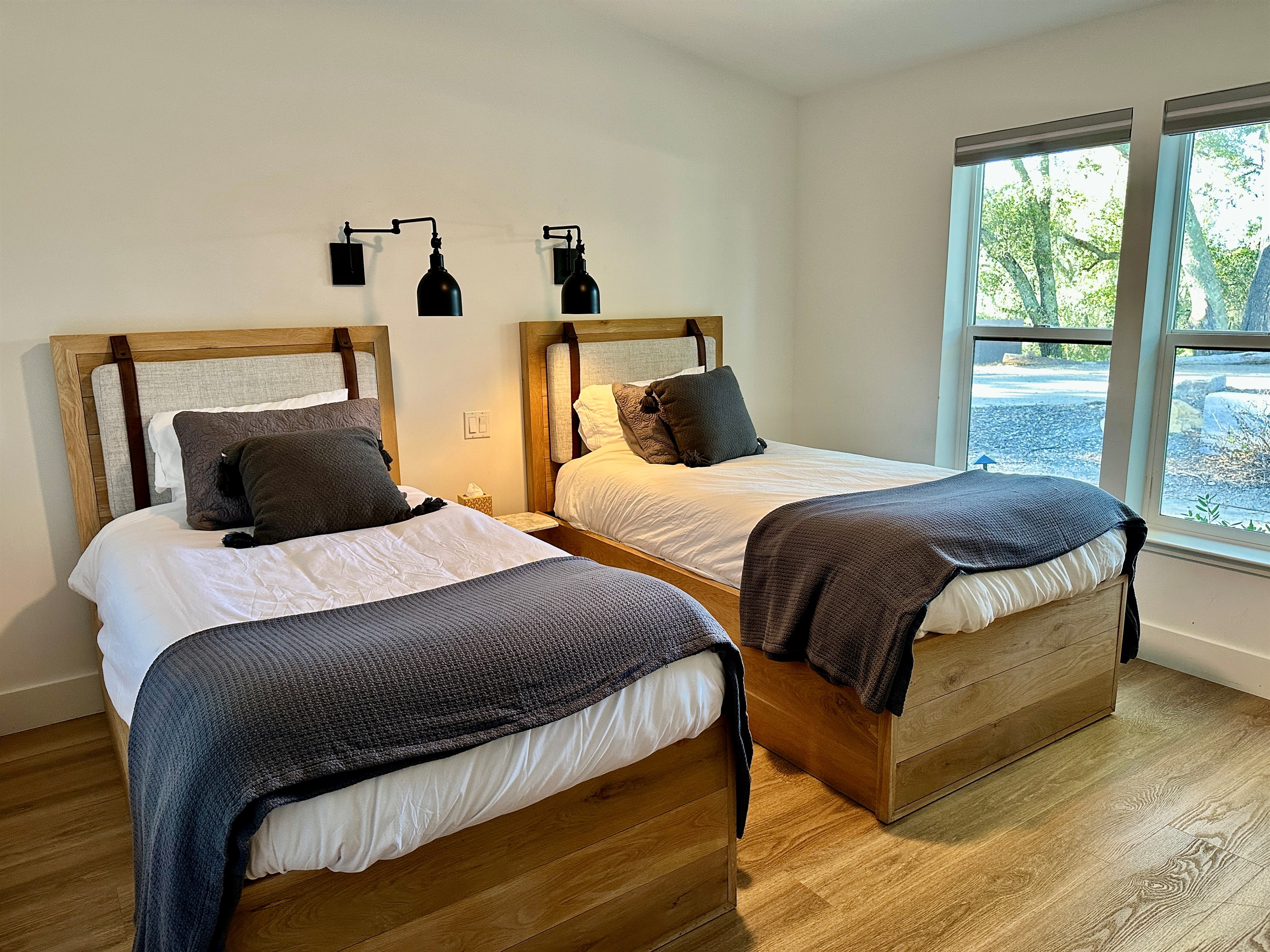 A sun-drenched retreat designed for relaxed comfort, with dual beds offering a stylish shared space for an airy, private feel.