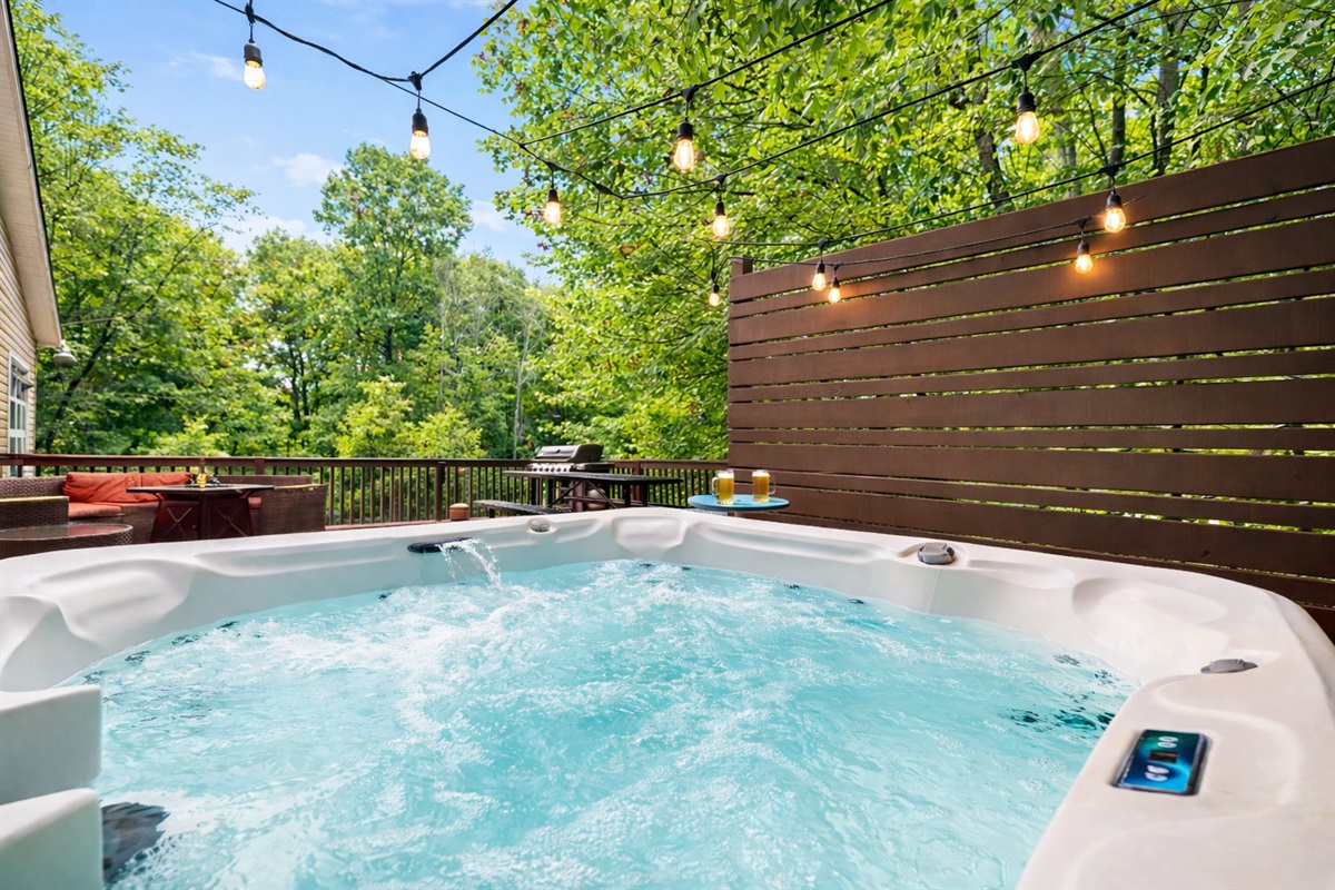 Soak in the bubbling hot tub under string lights, tucked behind a private fence