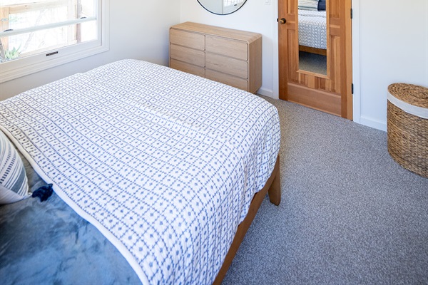 Comfortable bedroom featuring a queen bed, soft linens, and a calm setting for a restful night’s sleep