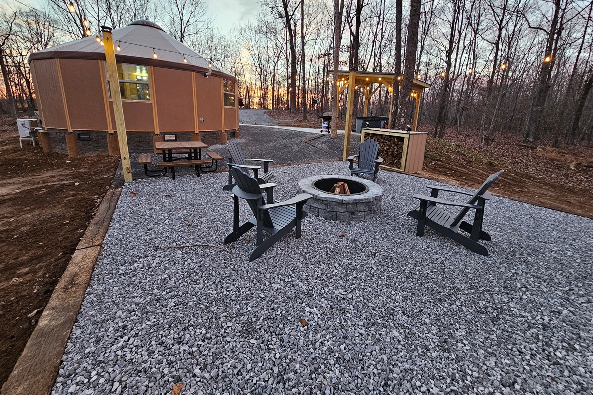 As the sun sets, Eagle Retreat glows with warm lights, a crackling fire pit, and a private hot tub pavilion—an intimate forest retreat designed for romance, relaxation, and unforgettable eveni