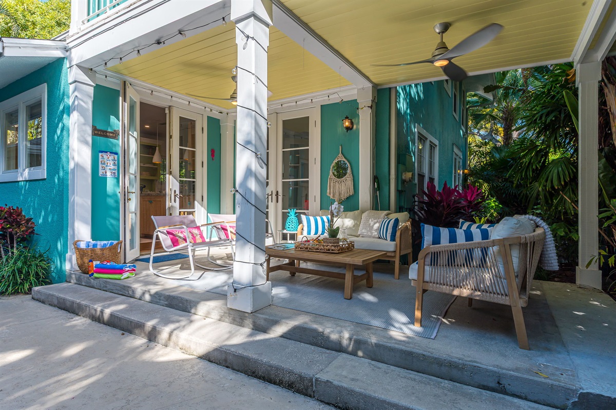 Step into your private tropical oasis featuring a heated pool, sun loungers, an outdoor shower, and a romantic string-lit cabana. Enjoy relaxing or entertaining under the covered patio with comfortable seating and dining, and magnificent pool views.