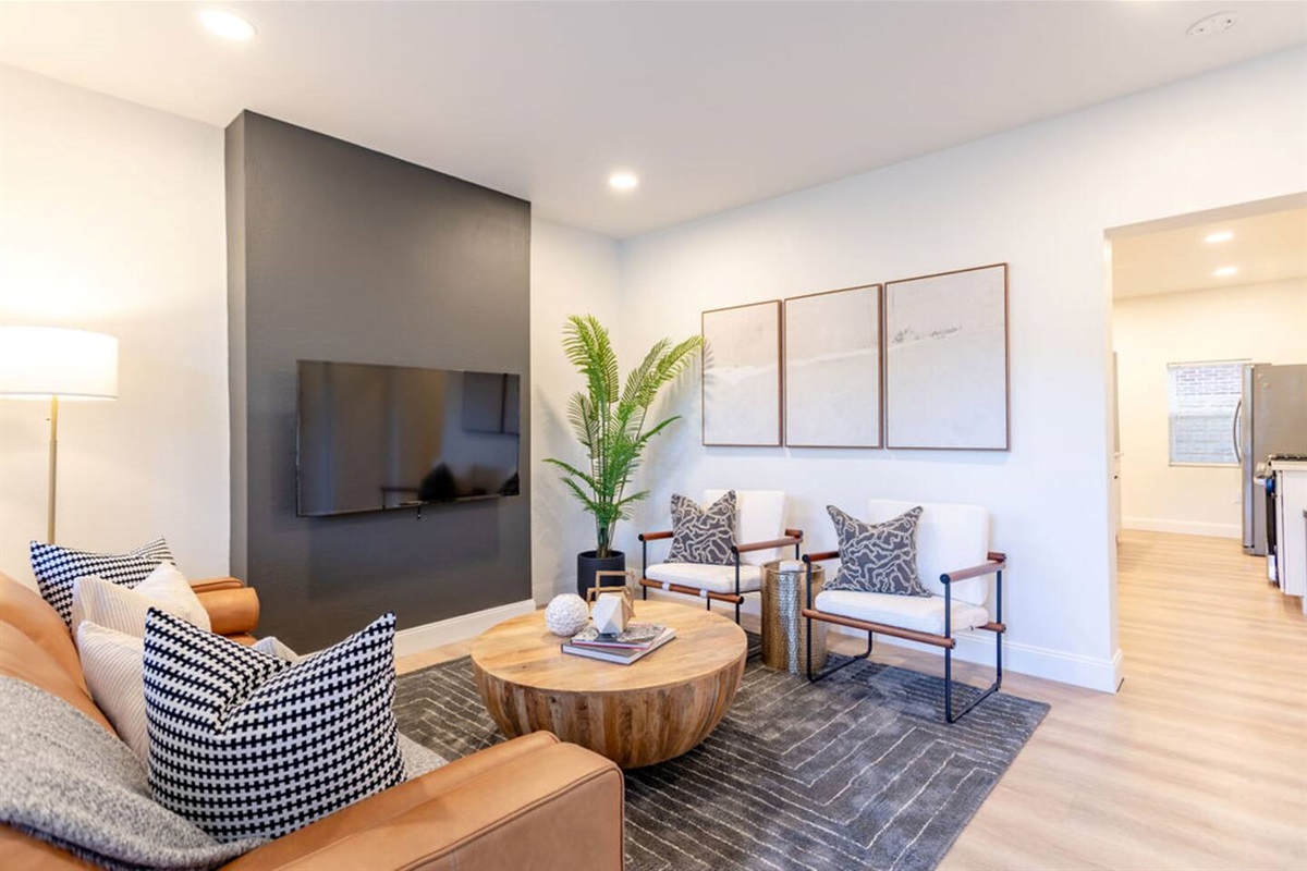 Spacious living area with modern furniture, offering a comfortable and stylish space to relax.