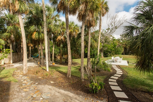 Take the small path left to the Zen Zone—hammock beside the tide pool, a bench built for stillness, and a chance to unplug. Or follow the front path to the outdoor dining area, future home of a pergola + life-size checkers
