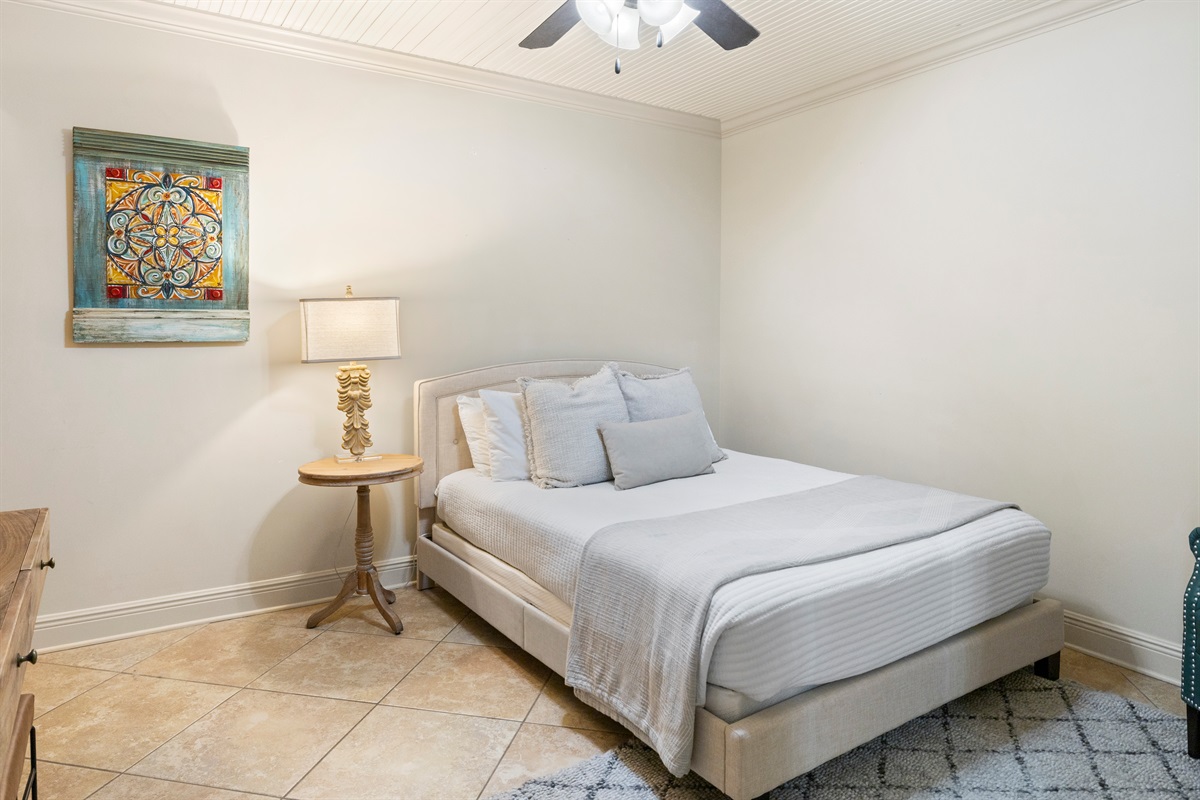 Cozy secondary bedroom with a queen bed for a restful stay.