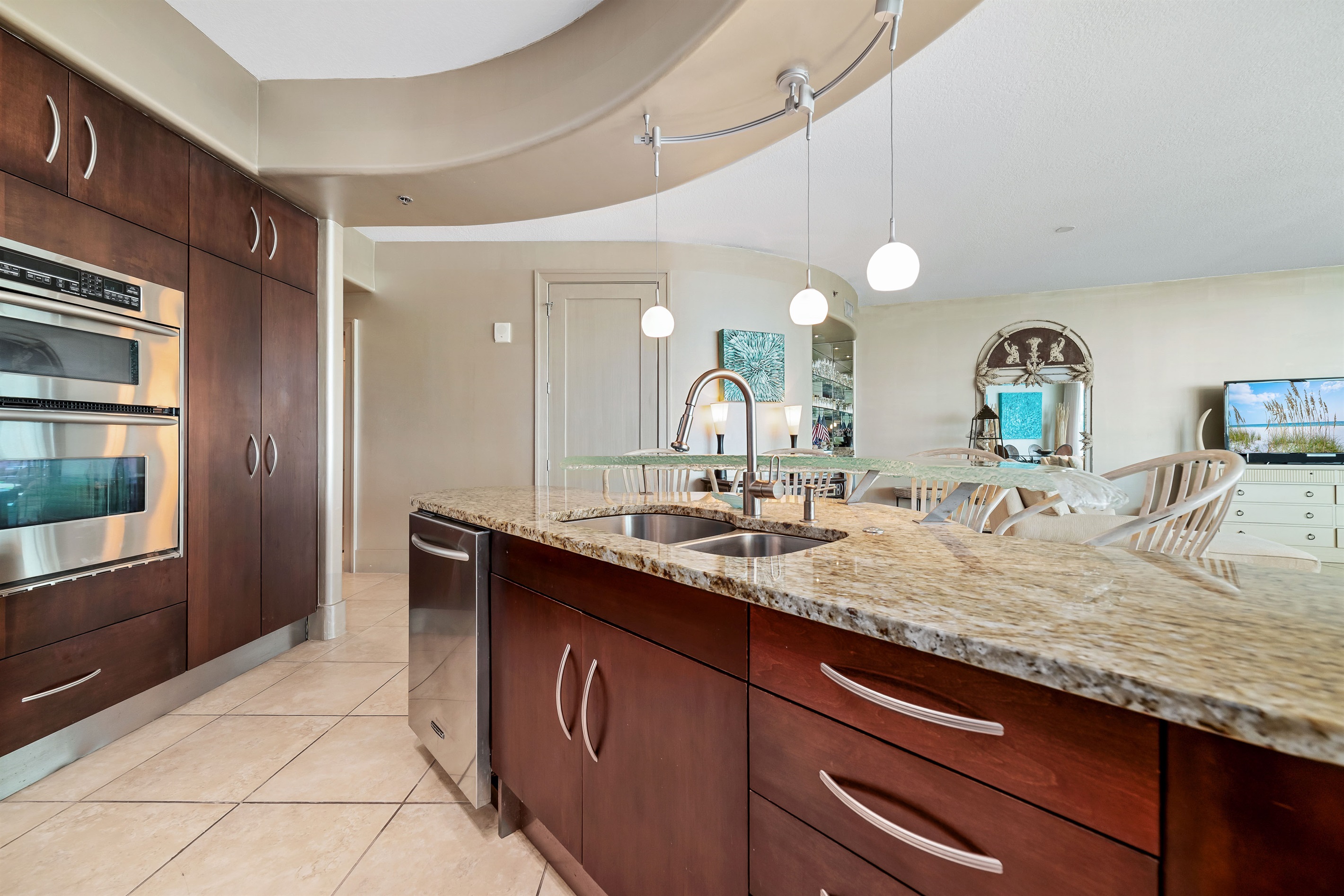 The modern kitchen island with bar seating offers a casual dining option, while the open layout maximizes natural light and showcases the stylish finishes throughout.