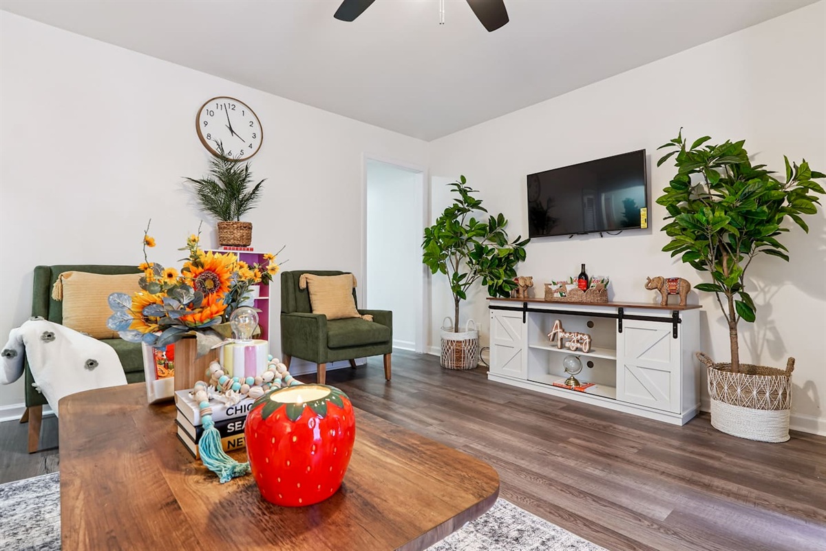 The living room features cozy furniture, including a comfortable blue couch, and an Amazon Fire-powered Smart TV for your entertainment. You’ll also find the Xfinity modem conveniently located here, convenient for ethernet connection.
