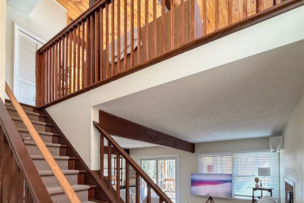Stairs going up to the second floor (living room, dining room, kitchen, and primary bedroom suite)