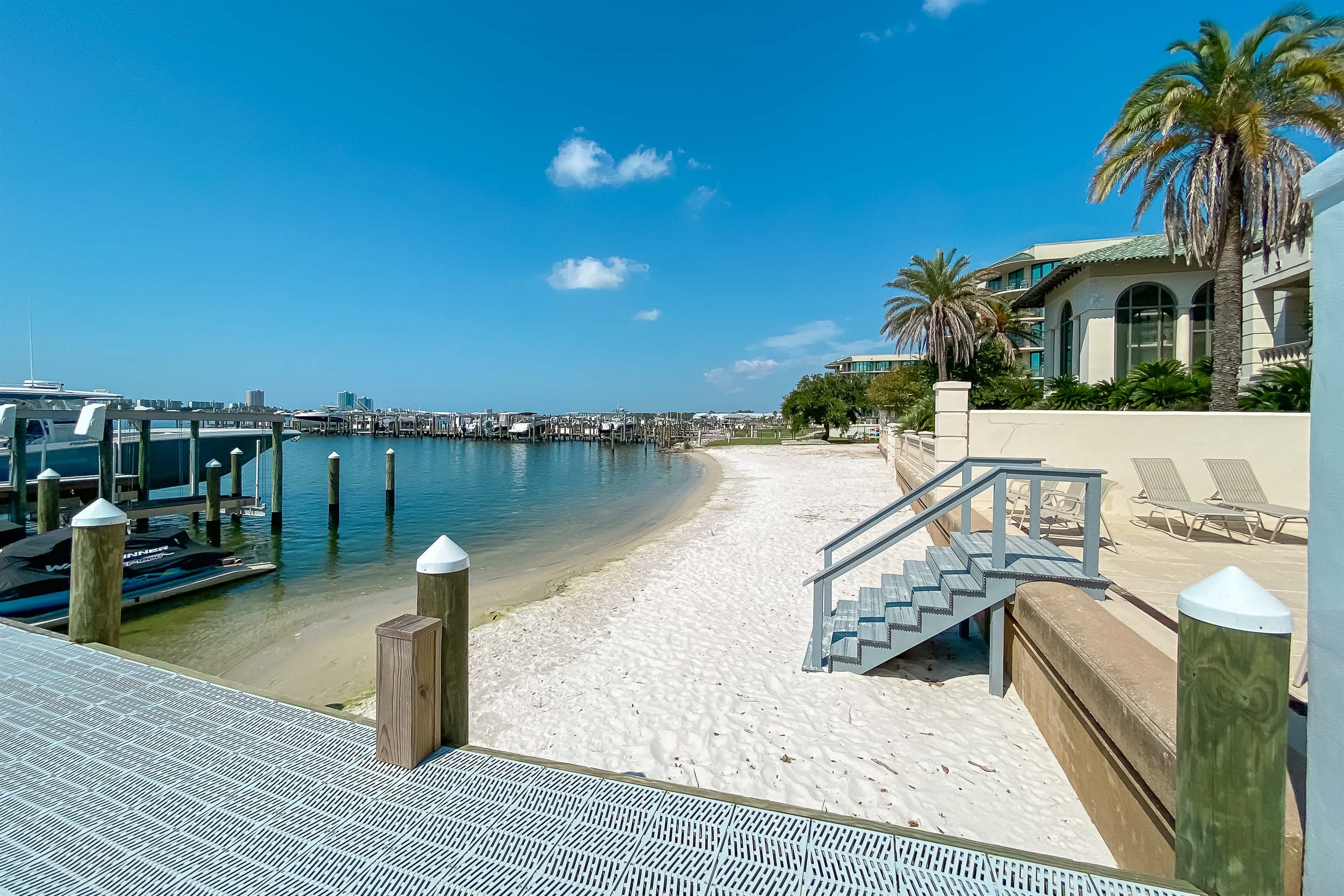 Lighthouse on the Bay II: Your coastal sanctuary. Enjoy the best of both worlds with private boat slips and a tranquil beach right at your doorstep.