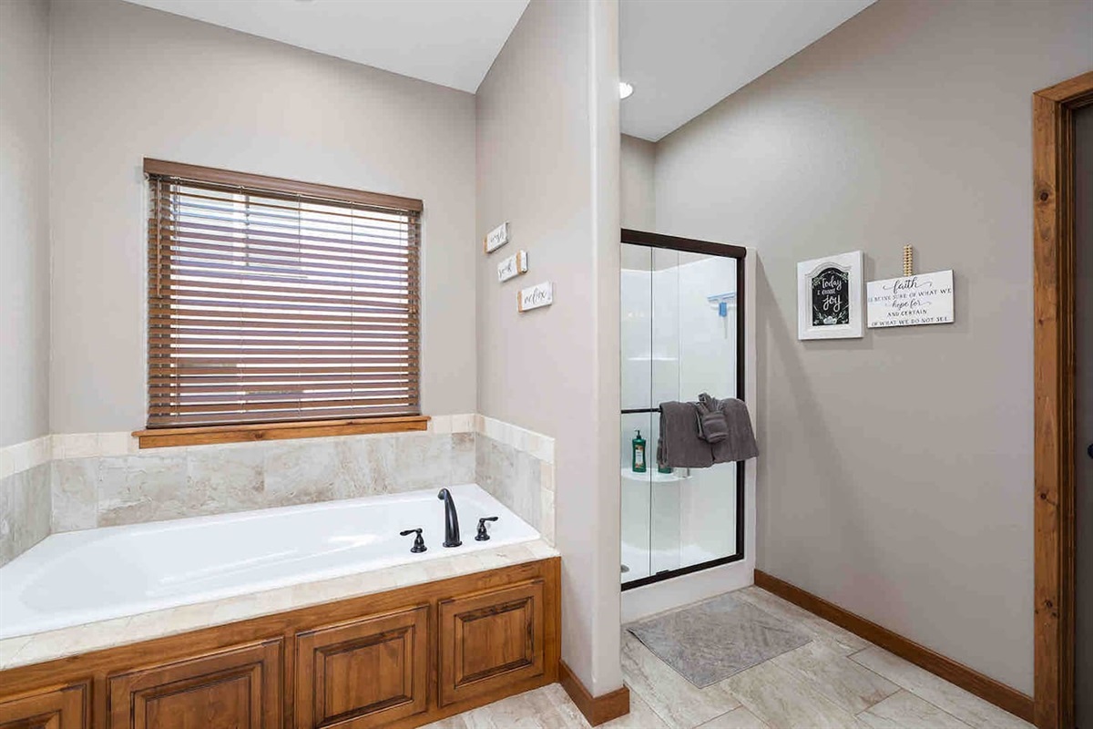 Main Level Attached Bathroom w/soaking tub, shower, toilet, and dual vanities