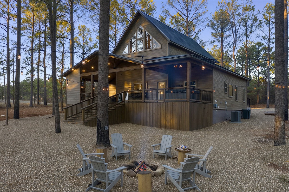 Large back porch and deck surrounded by peaceful pine trees.