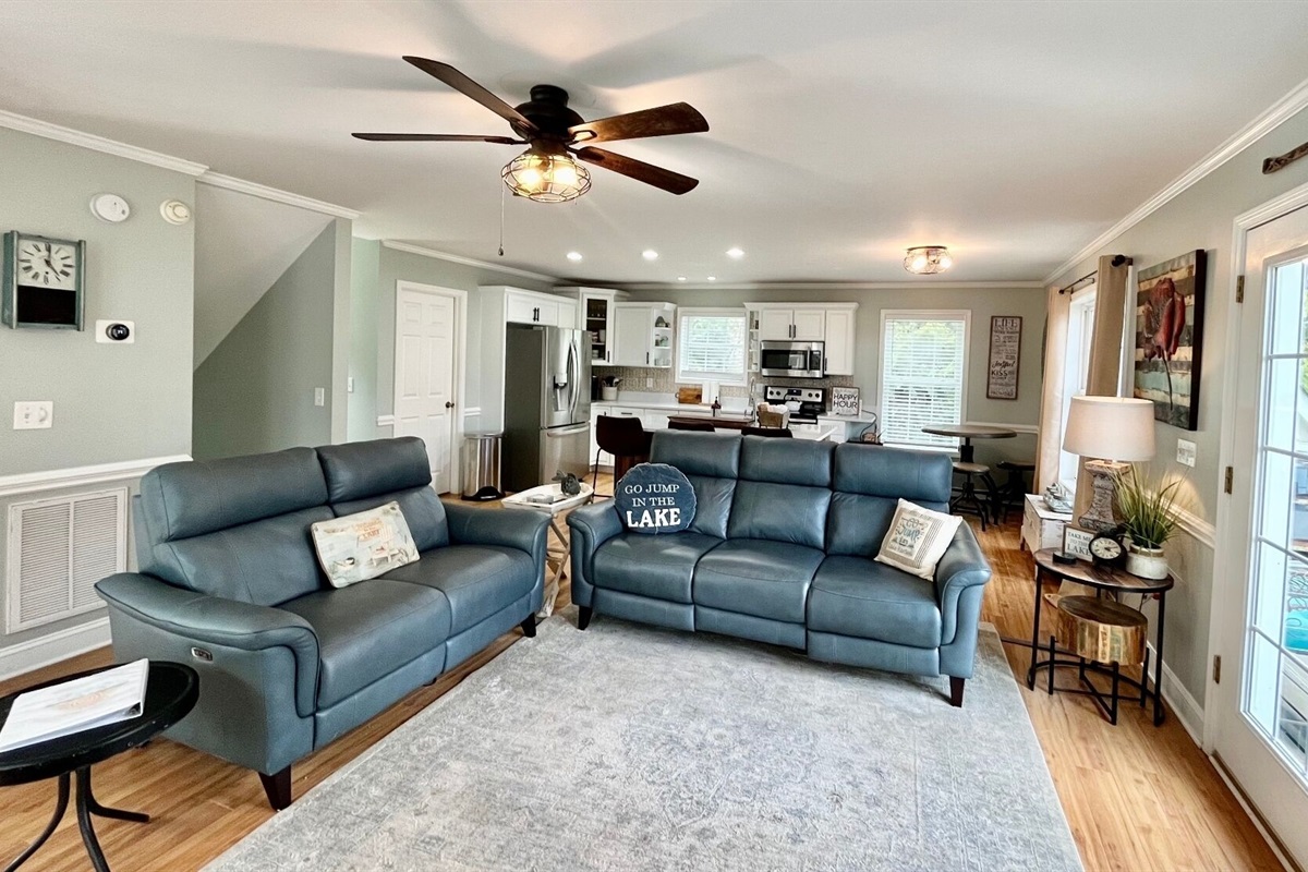 Living area with new sofas and remodeled kitchen