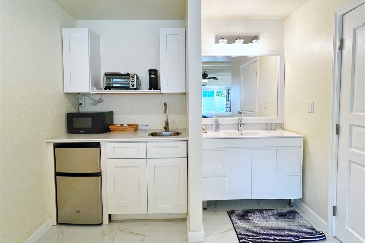 Snacks, coffee, and quick meals made easy in this compact and functional kitchen space.