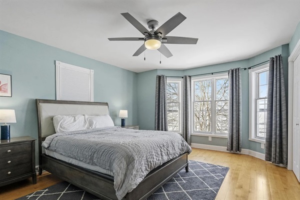 Relax in this peaceful queen bedroom featuring calming seafoam green walls, oversized lakeview windows filled with natural light, desk+chair, and two large closets for plenty of storage.