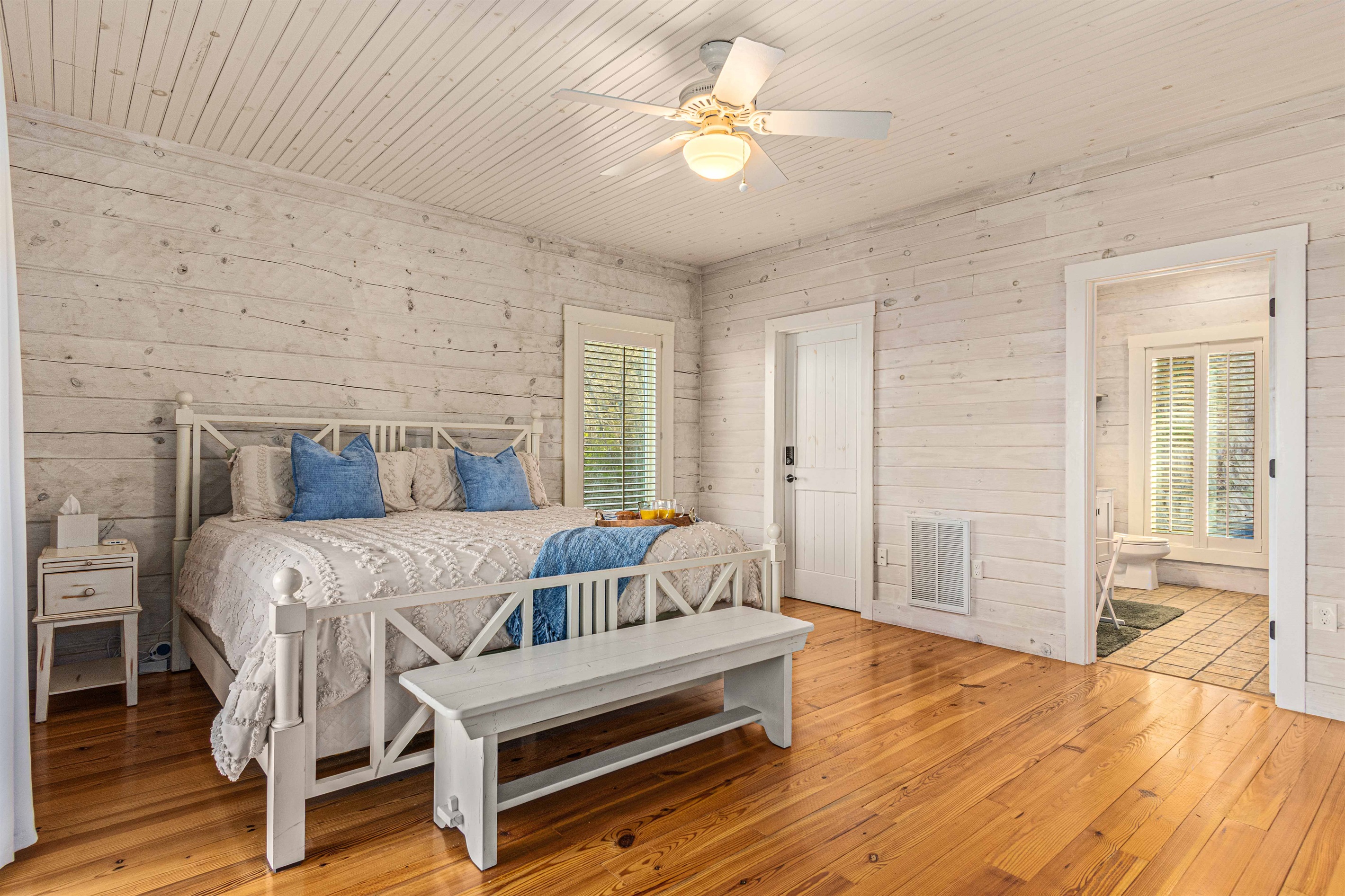Main Level King Bedroom 1: Light-filled retreat with rustic charm and a plush king bed for ultimate relaxation!