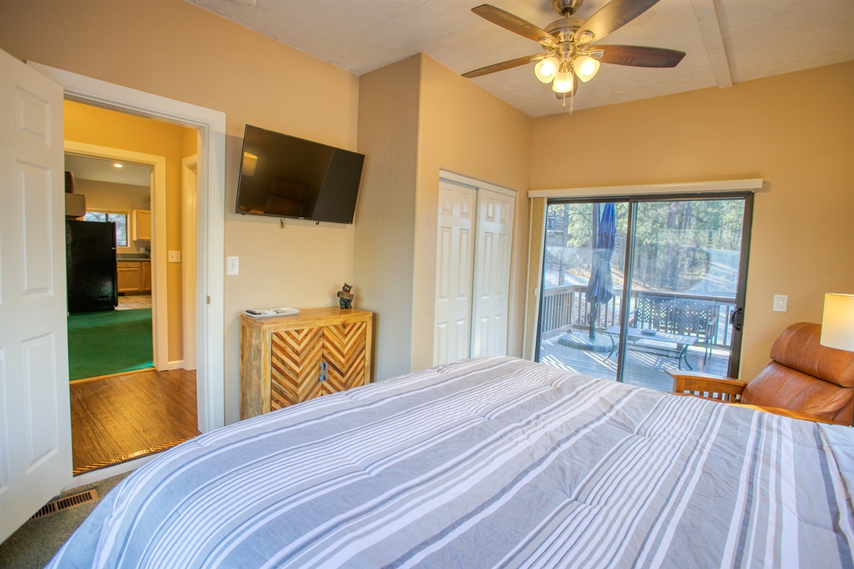 Wake refreshed in this cozy bedroom with peaceful balcony and forest views.