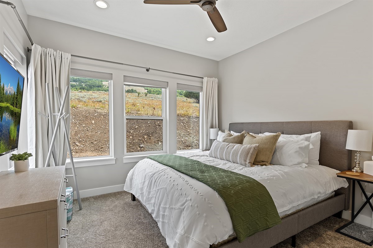Comfy king bedroom retreat with soft natural light and comfortable bedding
