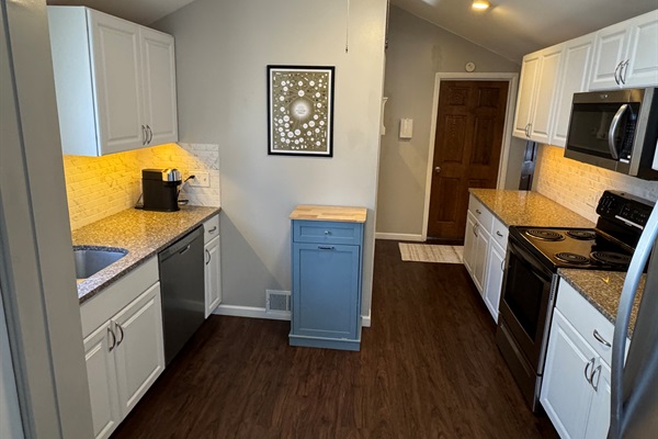 Kitchen: Dishwasher, electric stove, brand new Nespresso Vertuo, drip coffee maker, assortment of utensils and kitchen gadgets