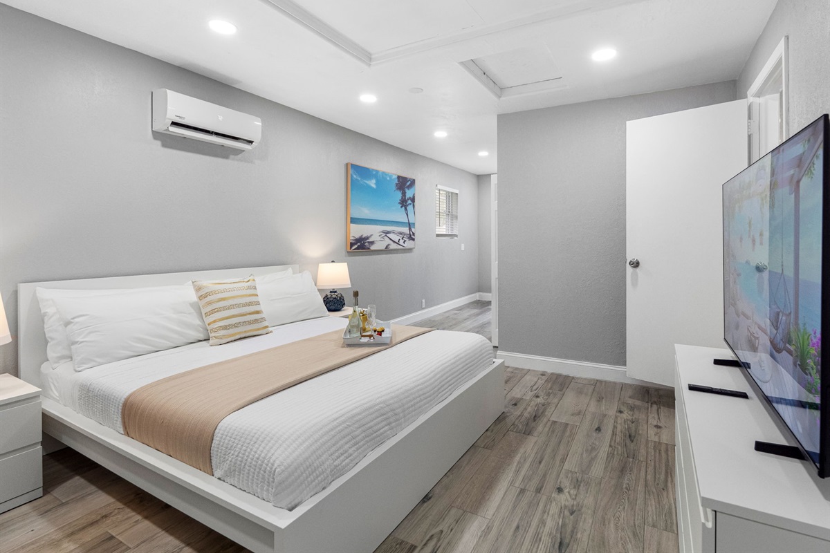 This peaceful bedroom is designed in soothing neutral tones, with sleek modern furnishings and soft ambient lighting for a truly relaxing stay.