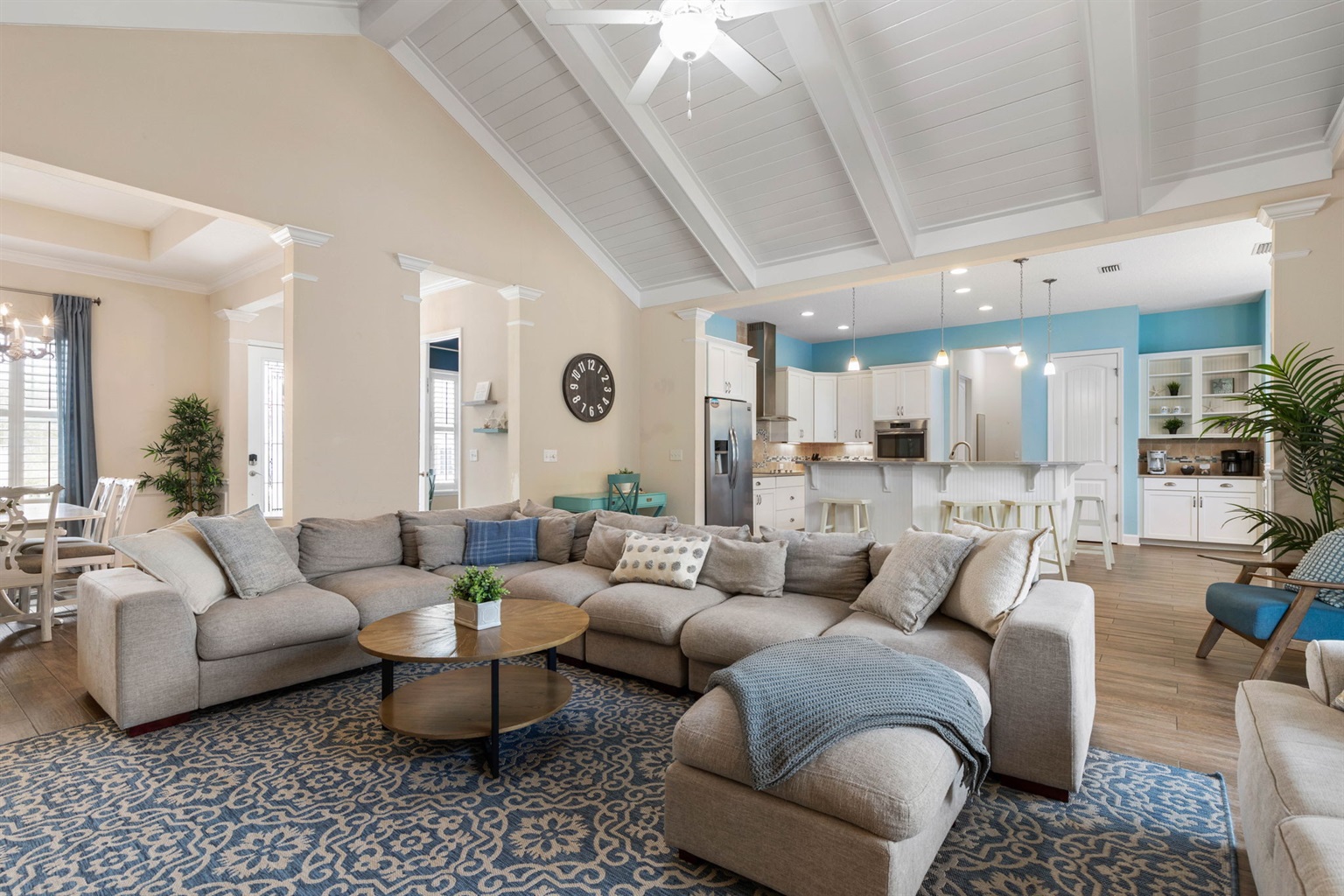 Gather beneath soaring ceilings, sink into the oversized sectional, and let the day slow down—coffee at the island, cards at the table, and everyone together in one bright, breezy space that feels made for connection.