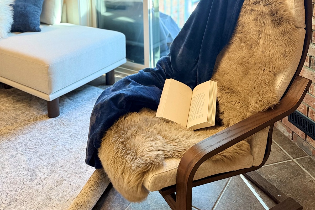 Cozy Fireside Escape: Unwind with a good book in the comfortable lounge chair by the gas fireplace in your Kimberley townhouse.