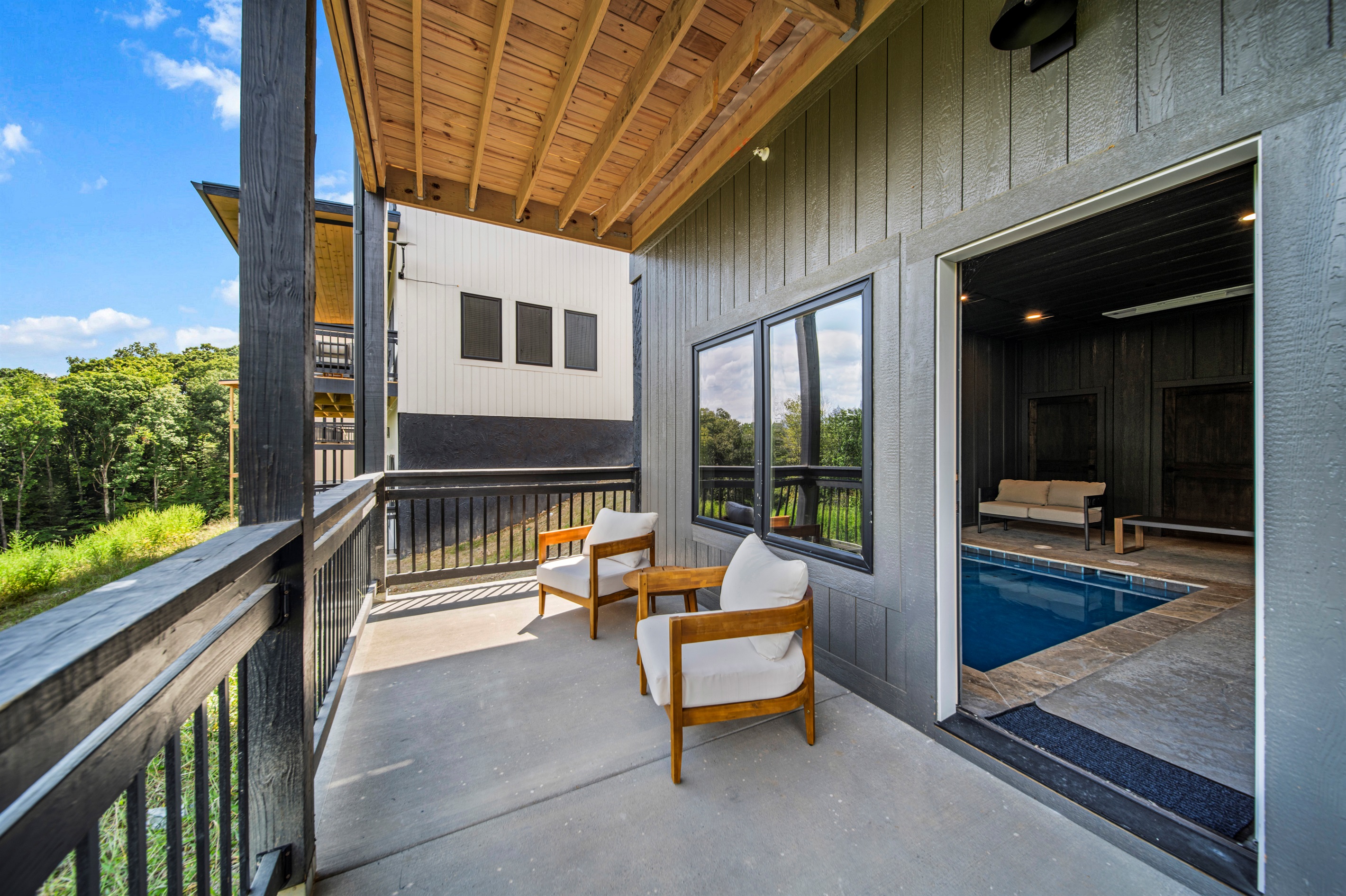 Relax on the lower-level terrace with a swing and seating area by the pool and game room.