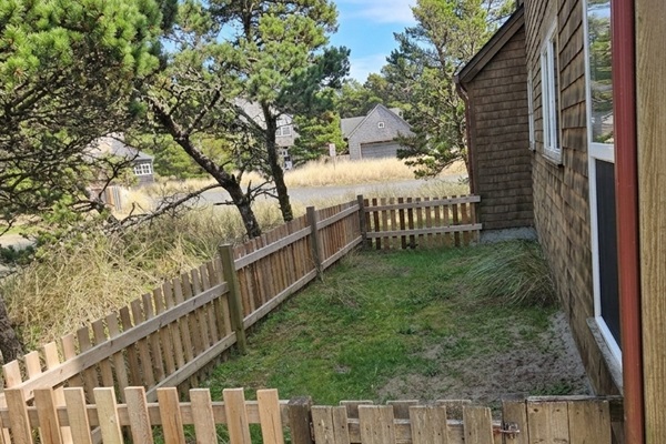 Fenced yard for dogs on the side of the home