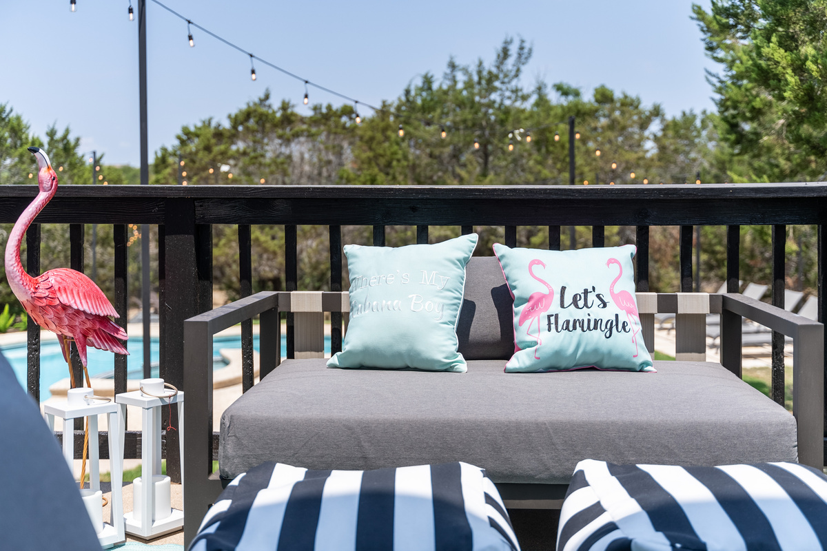 Cozy striped cushions and flamingo decor bring playful charm to the deck.