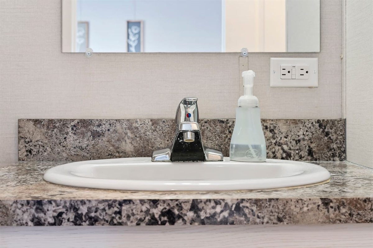 Modern sink and vanity area with ample counter space and essentials for your daily routine.
