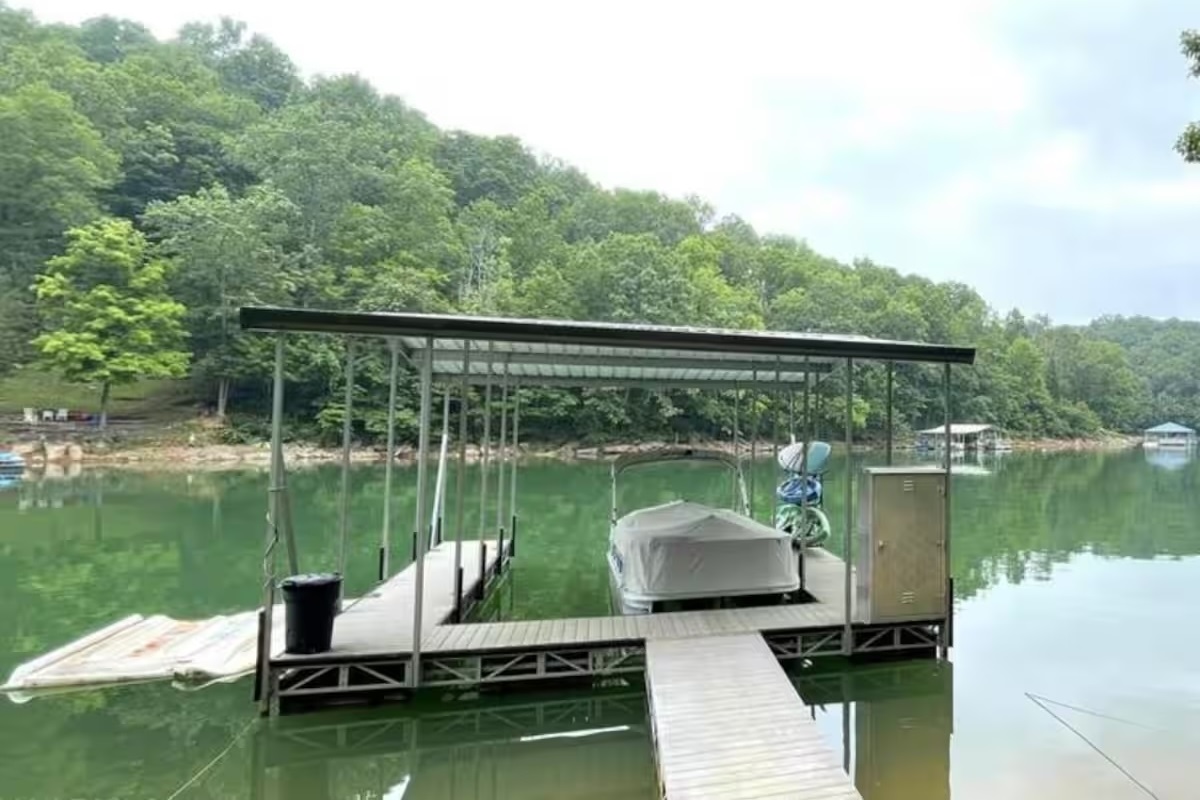 Large covered slip dock with kayaks and paddle board