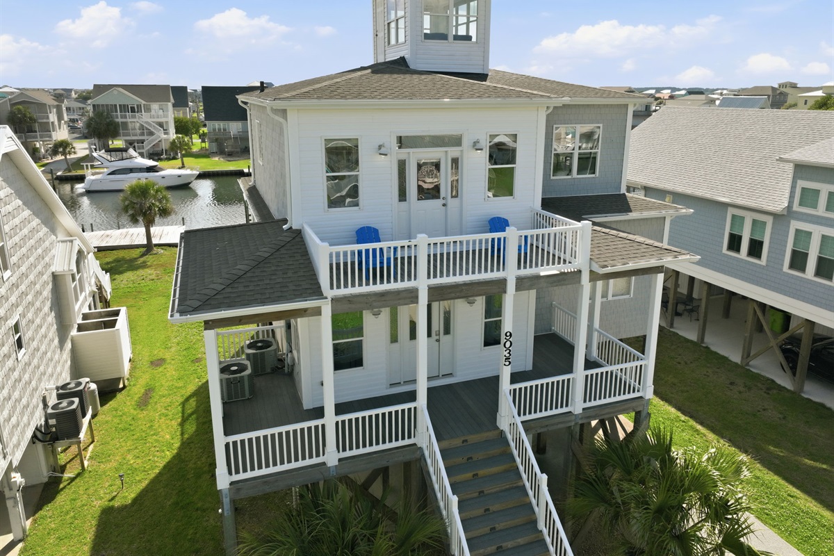 Aerial view showcasing the home&rsquo;s spacious decks, coastal design, and canal-front location