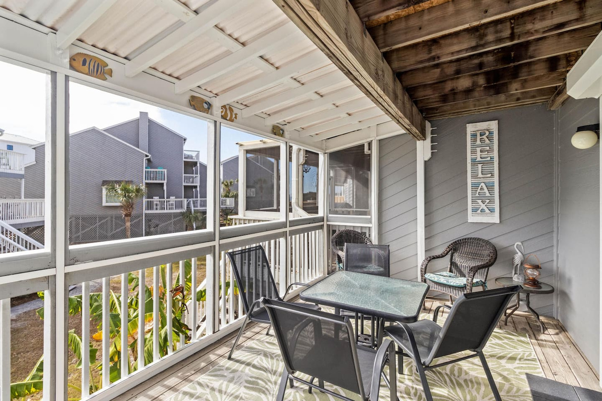 Grill dinner while the kids claim their spots at the table &mdash; the screened deck keeps bugs out and the Gulf breeze in.