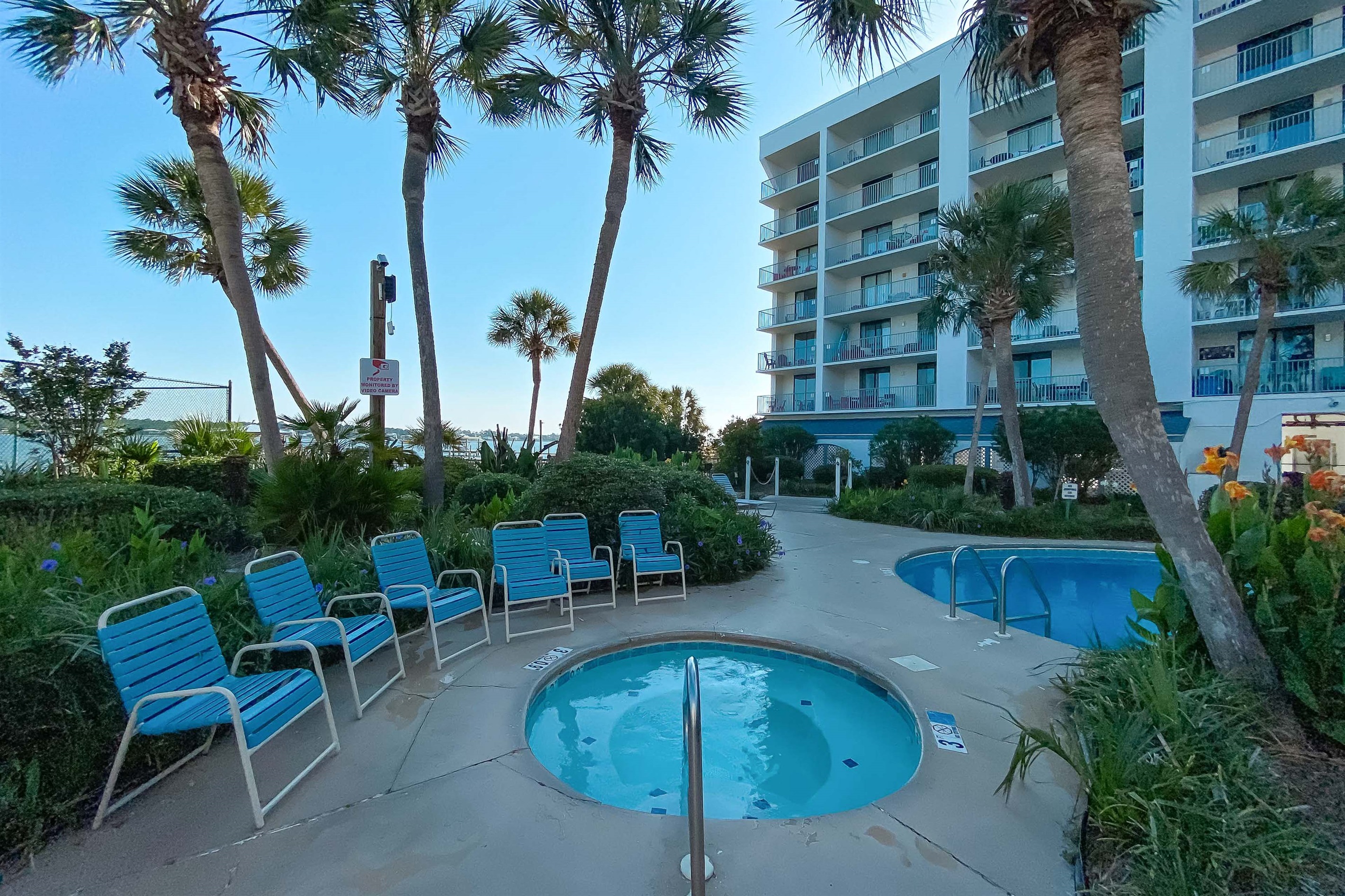 This charming outdoor space features a soothing hot tub and easy access to the pool, creating an ideal vacation retreat.