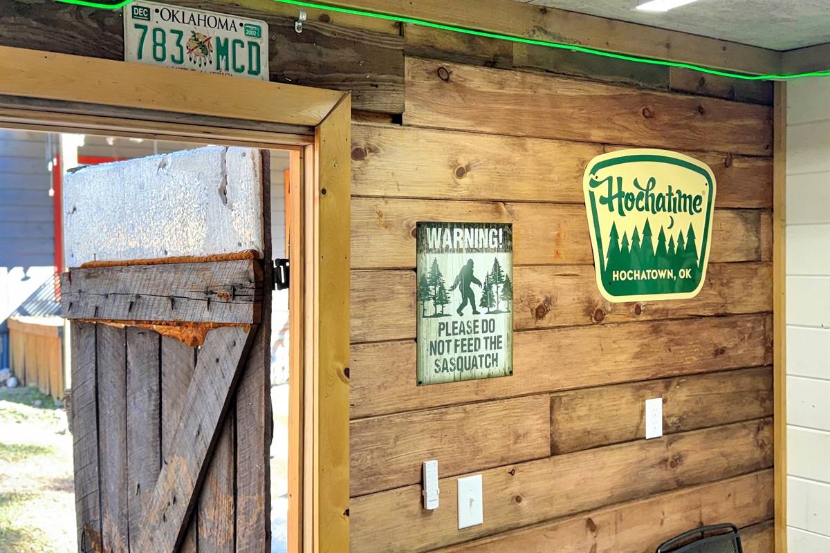 Reclaimed barnwood game shed adjacent to cabin.