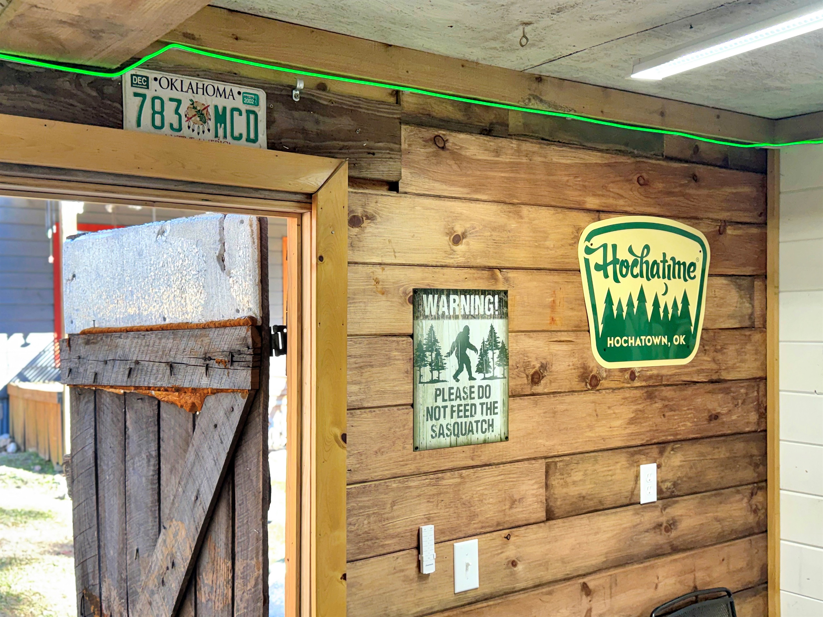 Reclaimed barnwood game shed adjacent to cabin.