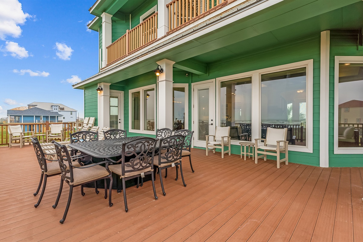 Rear Patio: Outdoor dining area perfect for family meals with a view.
