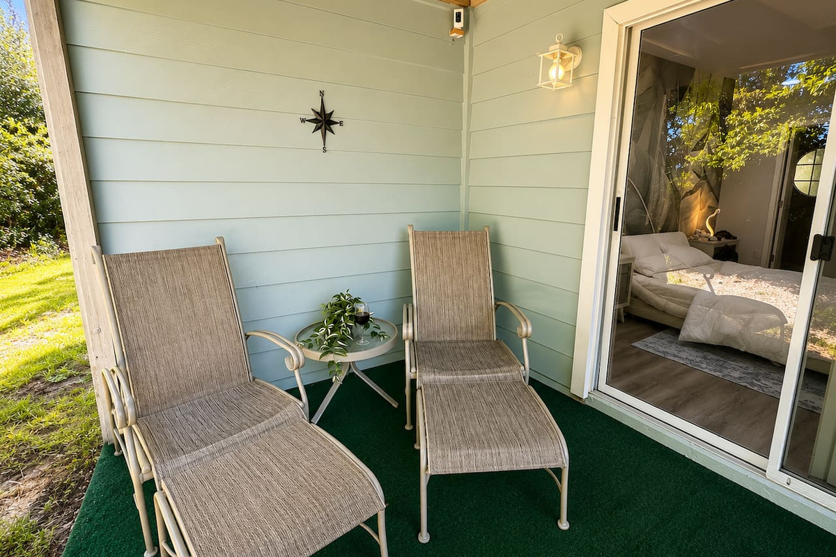 Private covered patio with comfortable seating and direct access to the bedroom.