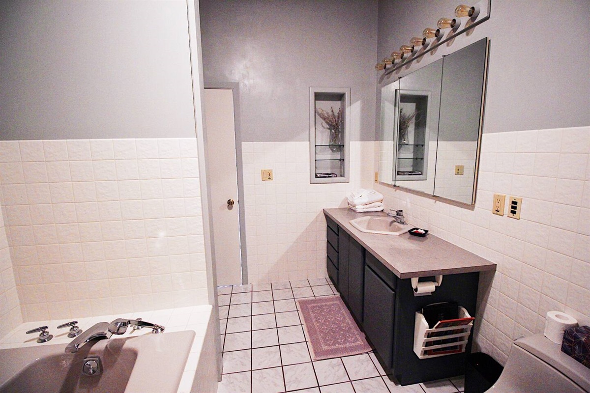 The large ensuite bathroom off the king master bedroom is fully stocked.