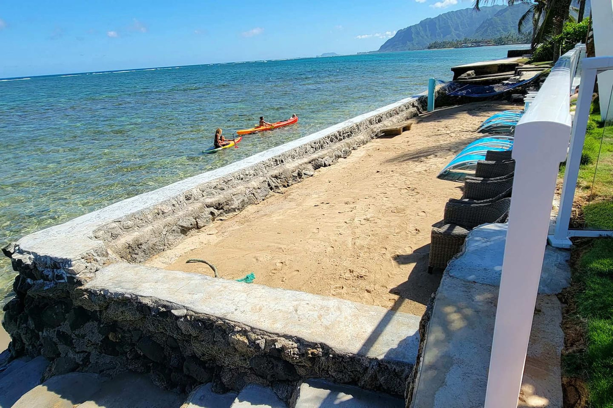 There are four girls in a couple of the home's two-person double-capacity kayaks in crystal clear snorkeling reef right in front of the home with only waist-deep water.Home is perfect for swimming, kayaking, snorkeling and fishing with exotic fishes