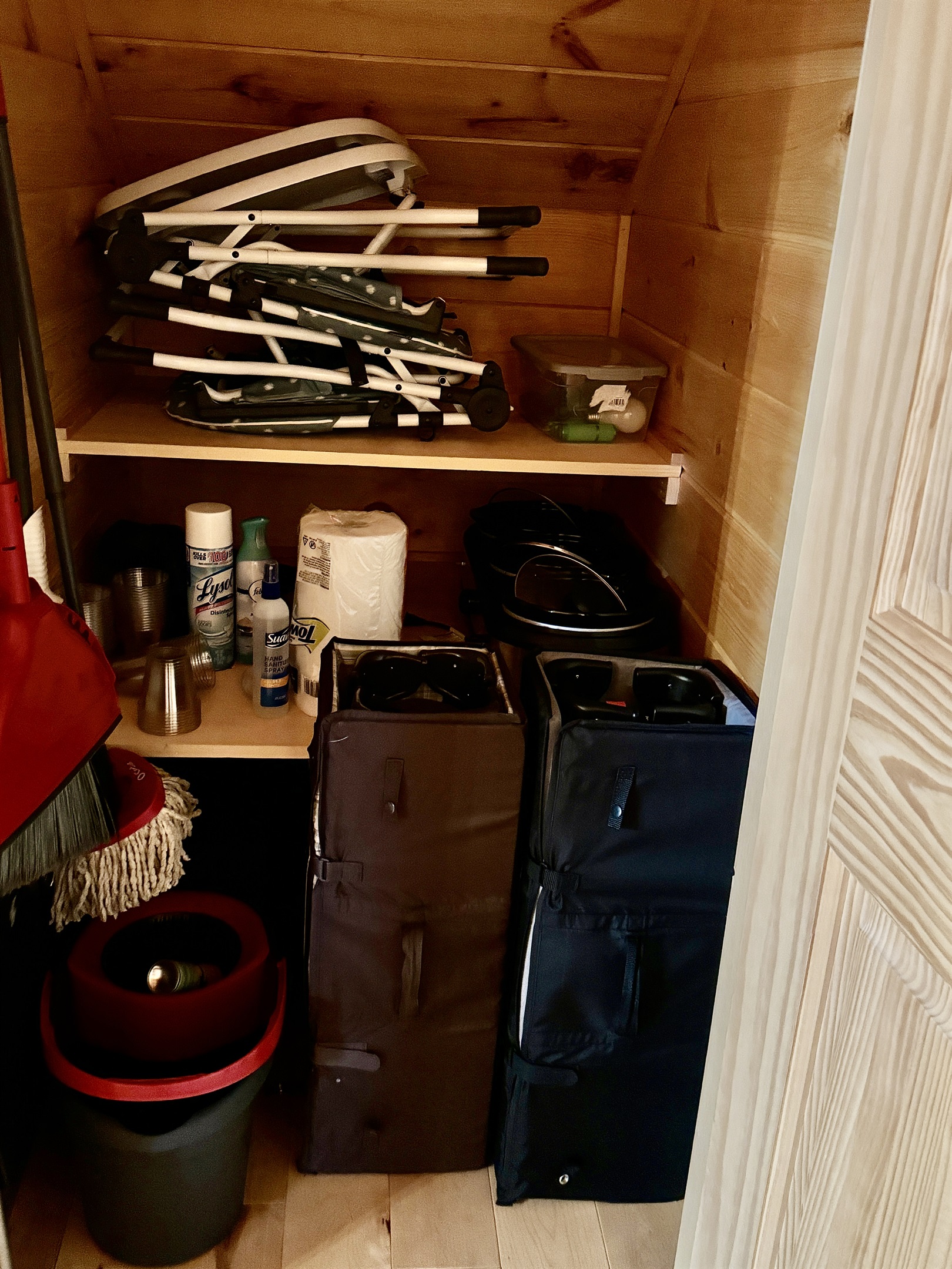 Closet in kitchen under stairs, pack n plays, high chairs and baby gates.