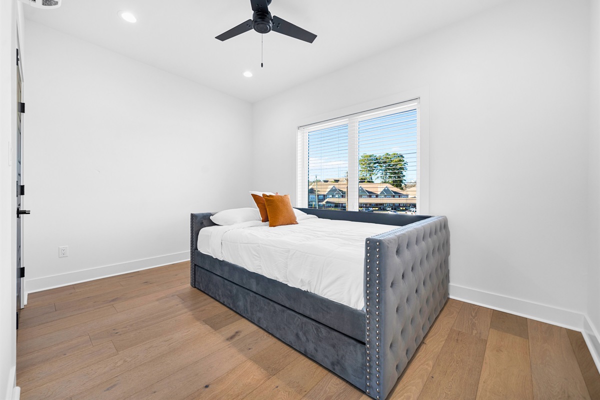 A tranquil queen bedroom that combines modern touches, soft neutral tones, and abundant natural light to create a calming retreat.