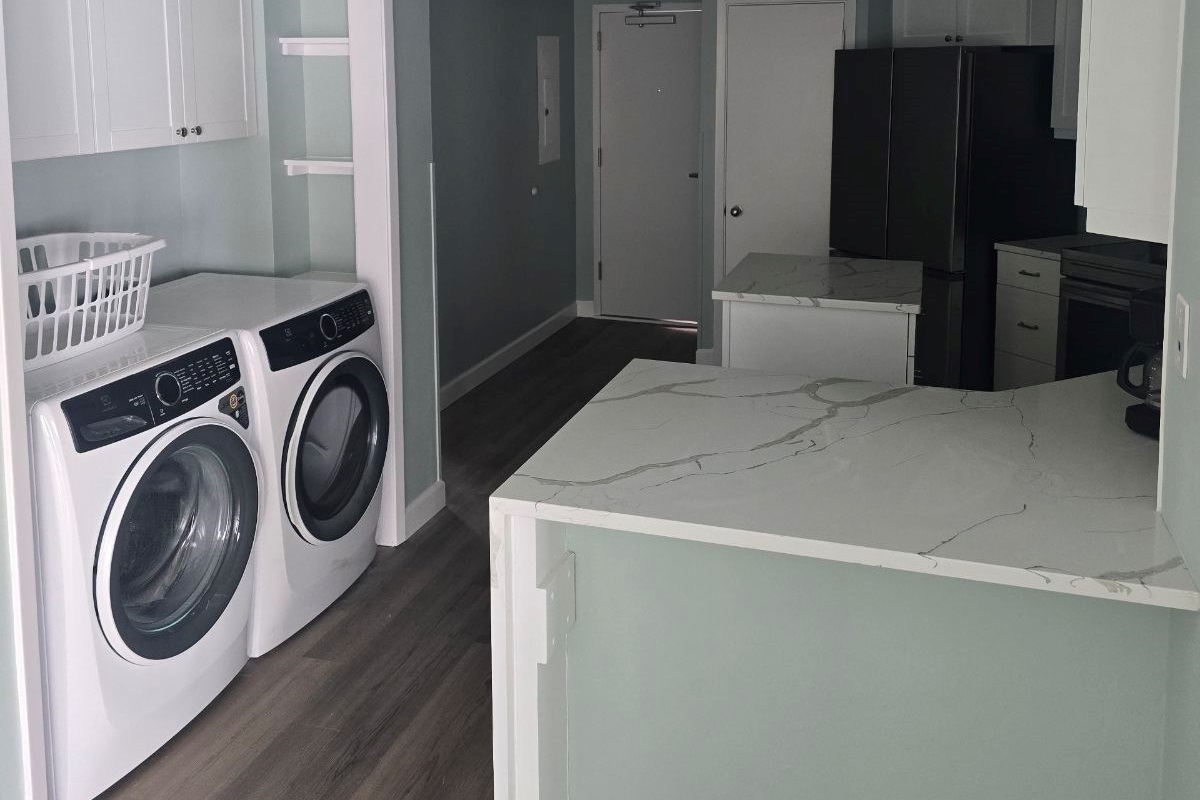 Brand New Everything!  Kitchen view with the updated Laundry station.