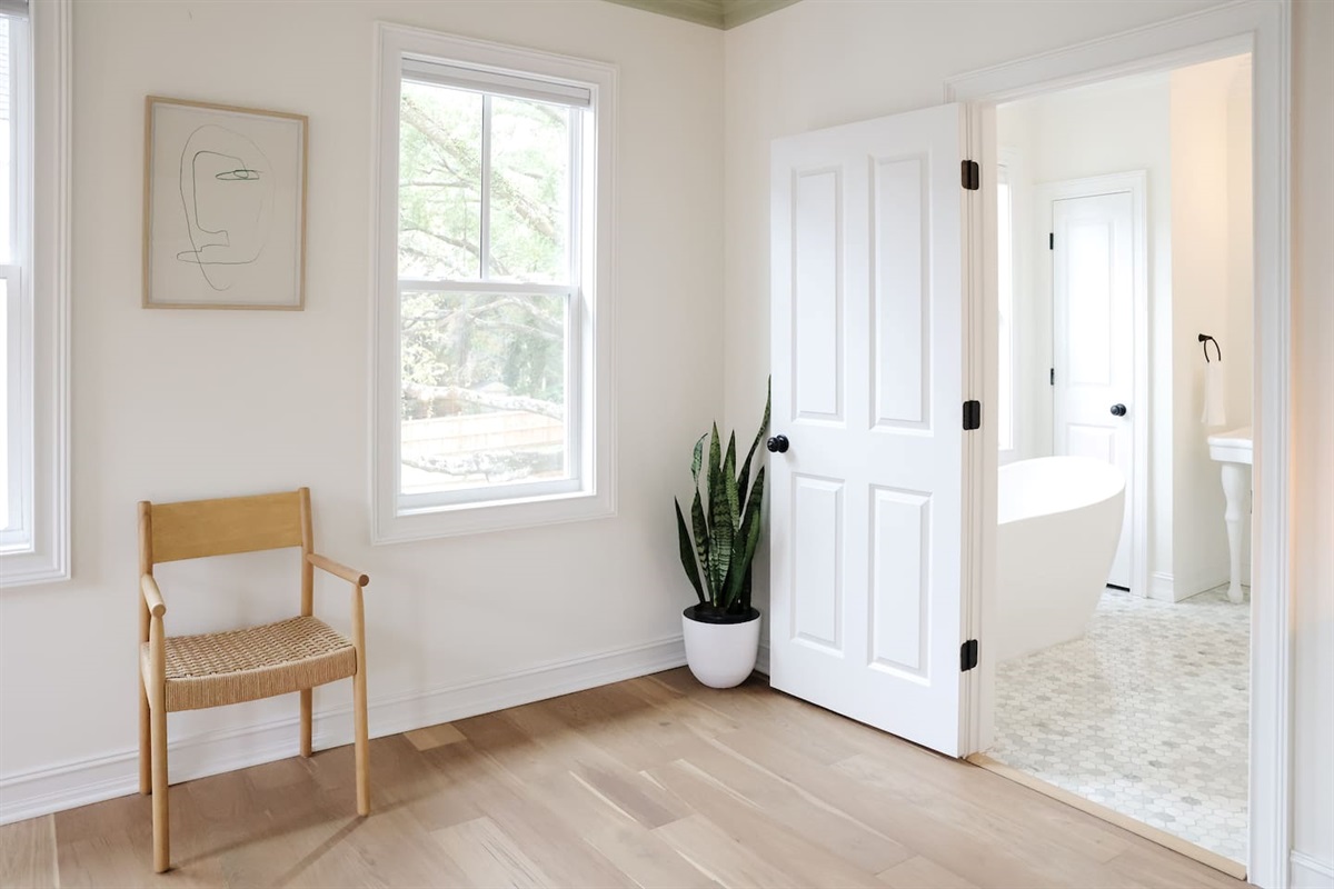 The spacious primary bedroom is a serene place to relax and recharge. The primary features a king sized bed, accents from CB2, walk-in closet, 50" Smart TV, and a full bath with a soaking tub and standup shower. 