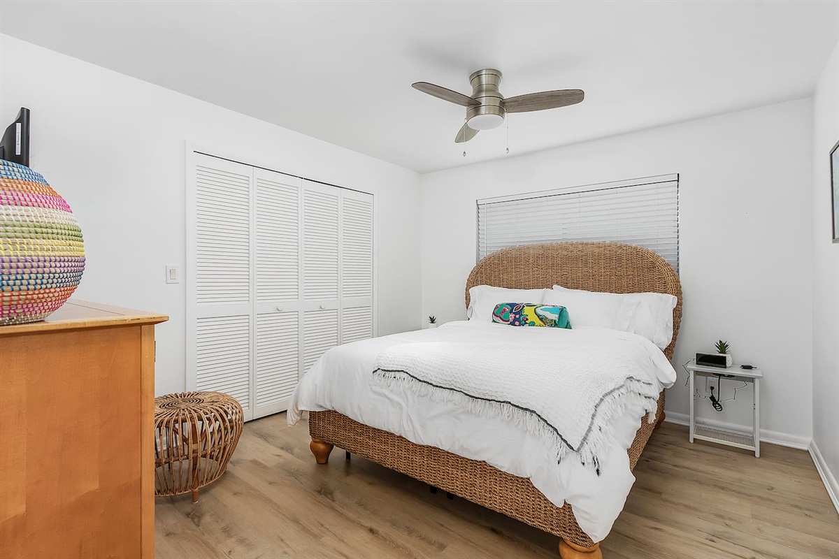 Unwind in the 1st Guest bedroom, featuring a queen-sized bed and a TV for your comfort and entertainment!